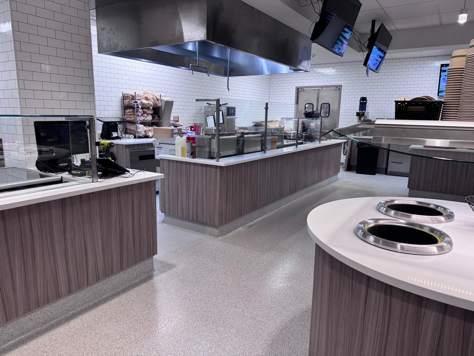 Corporate dining cafe cookline with exhaust hood and service counters